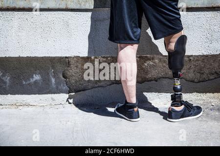 unrecognizable young man amputated with his leg prosthesis on an access ramp Stock Photo