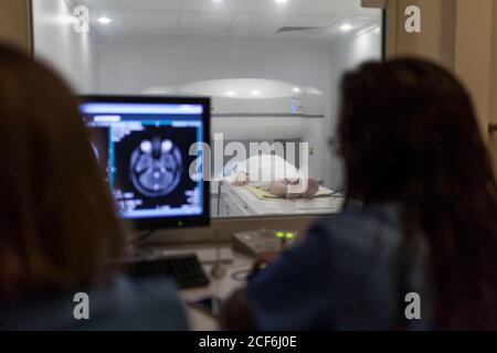 Doctors baling the MRI test in the control room Stock Photo