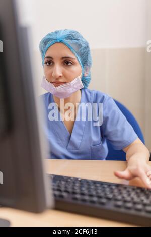 female surgeon using her computer in her office before the surgery Stock Photo