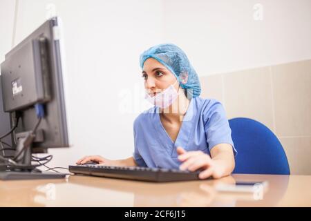 female surgeon using her computer in her office before the surgery Stock Photo