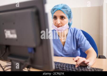 female surgeon using her computer in her office before the surgery Stock Photo
