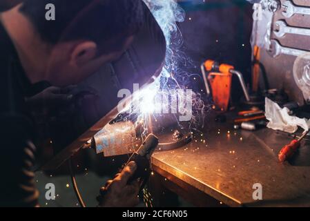 Professional welder in mask welding metal Stock Photo