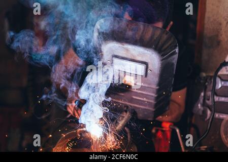 Professional welder in mask welding metal Stock Photo