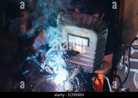 Professional welder in mask welding metal Stock Photo