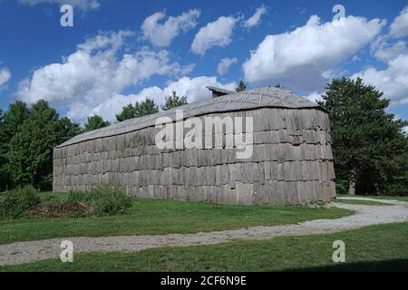 Halton, Canada - September 3, 2020:  An authentic reproduction of an Iroquois longhouse made of tree bark in a location where an ancient village stood Stock Photo