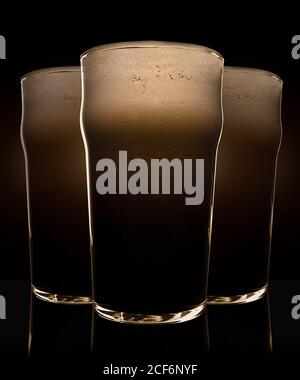 Glass of beer with heavy dark foam Stock Photo
