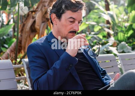 Aged handsome man using digital tablet outdoors Stock Photo