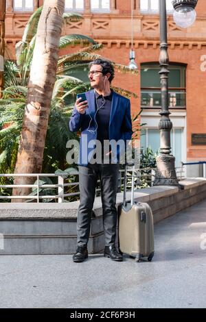 Senior businessman in blue jacket using smartphone Stock Photo