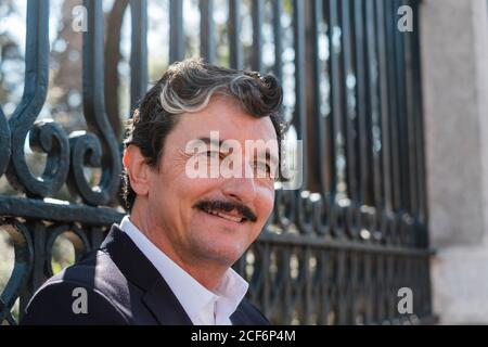 Elderly accomplished businessman waiting for meeting on bench outdoors Stock Photo