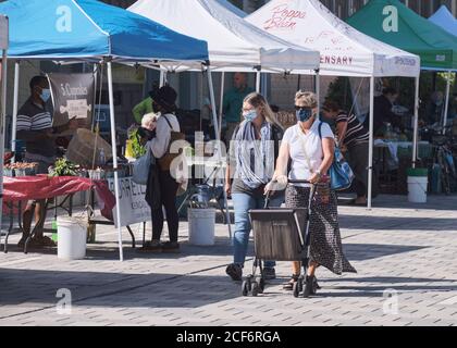 Landsdown Farmers Market in Ottawa: People walking around area with majority wearing face masks keeping distance  buying produce Stock Photo