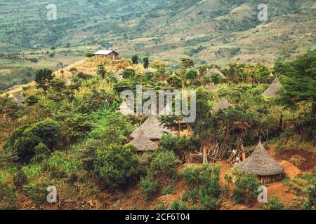 View of small thatched cabins of tribal village in green valley of Ethiopia Stock Photo