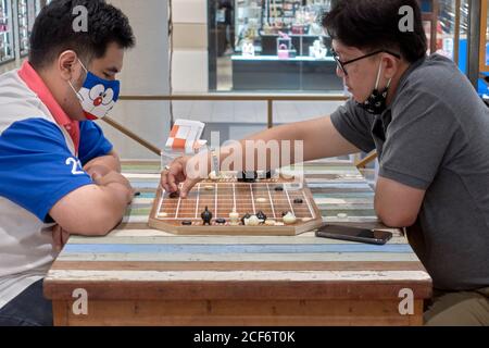 Thailand chess. Men playing Makruk, which is a Thailand version of chess. Southeast Asia Stock Photo