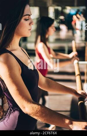 Side view of confident serious dancers practicing ballet in sunlight. Stock Photo