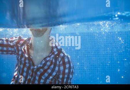 Dressed man in swimming pool Stock Photo