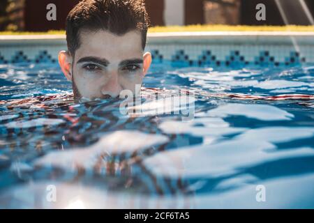 Dressed man in swimming pool Stock Photo