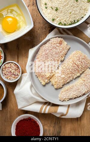 Chicken fingers breaded in panko with spicy, mustard sauce, soy sauce, spinach, oregano. Raw ingredients, recipe from above Stock Photo