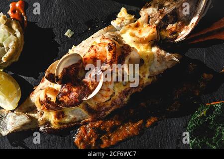 Sea delicacy of baked fish in restaurant Stock Photo