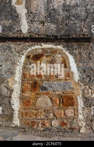 Frame of little rocks in concrete wall of building in Tangier, Morocco Stock Photo