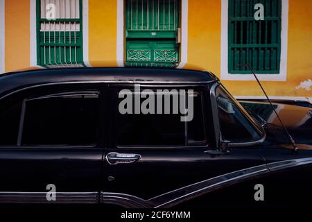 Small Street With Black Vintage Car In Roadside Between Historical Colorful Buildings With Bars On Windows In Cuba Stock Photo Alamy