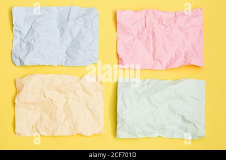 multicolored crumpled sheets on yellow background, texture for web design screensavers. Template for various purposes or creating packaging. Stock Photo