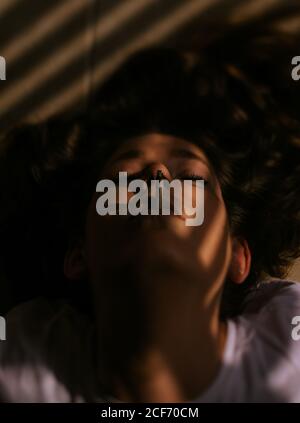 Woman lying down with eyes closed Stock Photo - Alamy