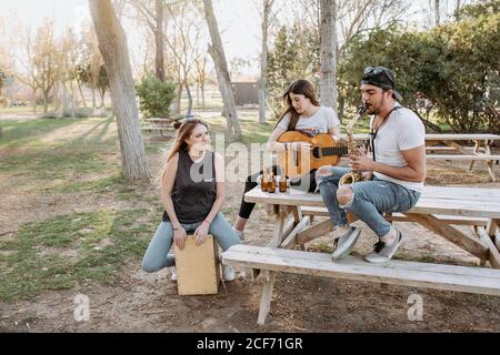 Cheerful musicians having fun in park Stock Photo