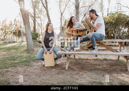 Cheerful musicians having fun in park Stock Photo