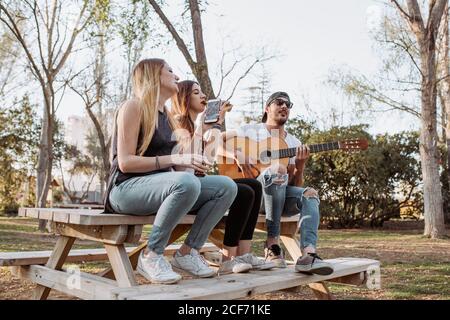 Cheerful musicians having fun in park Stock Photo