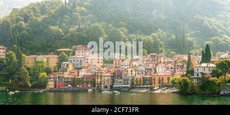 Panorama of Morning View on Colorful Town Varenna on Lake Como in Italy. Bright Architecture with Yellow Buildings. Stock Photo