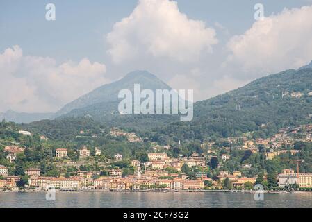 Panorama of Menaggio Town on Lake Como in Italy. Bright Architecture with Colorful Buildings. City Embankment with Tourists. View from Water. Stock Photo