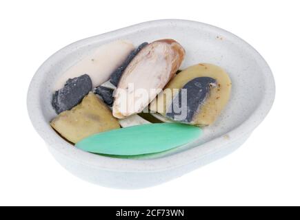 Old rustic dry cracked soap  slices in plastic broken dishe. Isolated studio macro Stock Photo