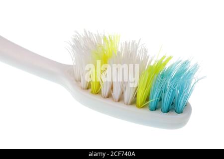 Old toothbrush with worn out bristles isolated  macro Stock Photo