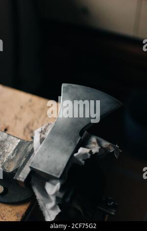 Sharp steel axe on table in workshop Stock Photo