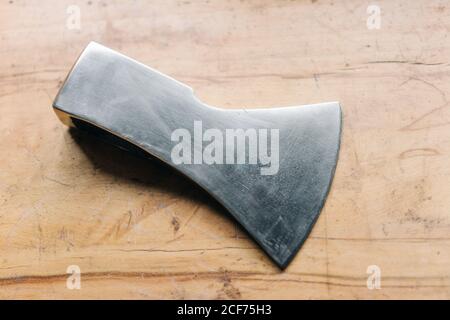 Sharp steel axe on table in workshop Stock Photo