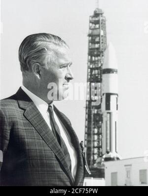 Dr. Wernher von Braun stands in front of a Saturn IB launch vehicle at Kennedy Space Flight Center. Dr. von Braun led a team of German rocket scientists, called the Rocket Team, to the United States, first to Fort Bliss/White Sands, later being transferred to the Army Ballistic Missile Agency at Redstone Arsenal in Huntsville, Alabama. They were further transferred to the newly established NASA/Marshall Space Flight Center (MSFC) in Huntsville, Alabama in 1960, and Dr. von Braun became the first Center Director. Under von Braun's direction, MSFC developed the Mercury-Redstone, which put the fi