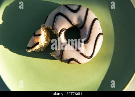Donuts with icing and chocolate on plate Stock Photo