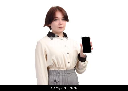 young businesswoman, or Manager, holds a smartphone in his hand. Isolate on white background Stock Photo