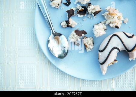 Donuts with icing and chocolate on plate Stock Photo