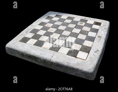 Ancient stone chessboard with marble cells. Isolated on black Stock Photo