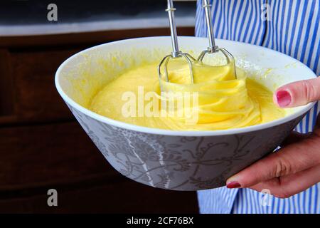 From above anonymous Woman using mixer to prepare batter for pastry in kitchen at home Stock Photo