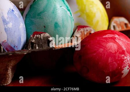 Set of painted Easter eggs in container on table Stock Photo