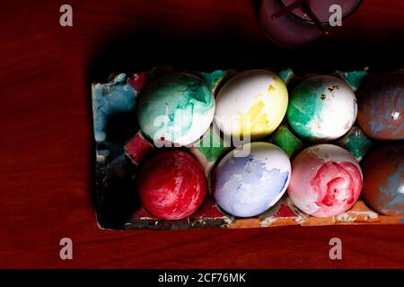 Set of painted Easter eggs in container on table Stock Photo
