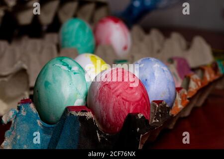 Set of painted Easter eggs in container on table Stock Photo