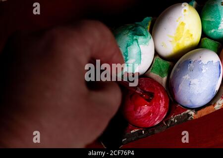 Crop hand painting Easter eggs Stock Photo
