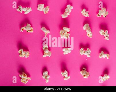 From above collection of fresh tasty popcorn placed on pink background Stock Photo