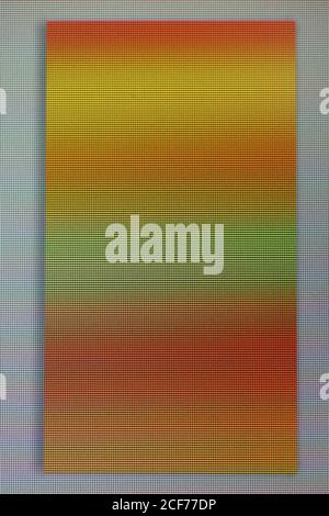 A macro photo of a chaotic colored striped noise on the broken phone screen. A well-seen pixel structure Stock Photo