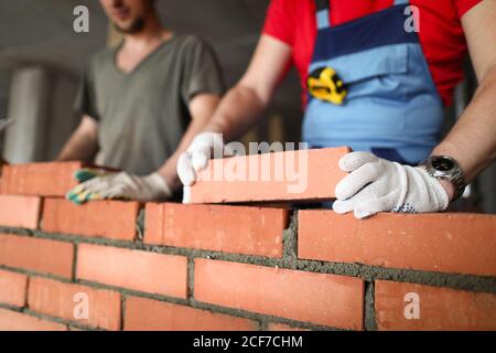 Bricklayers st construction site laying bricks Stock Photo