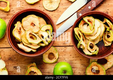 Apple chips on rustic wooden background.Dried apples Stock Photo