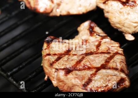 Steak on the grill with a lozenge pattern Stock Photo