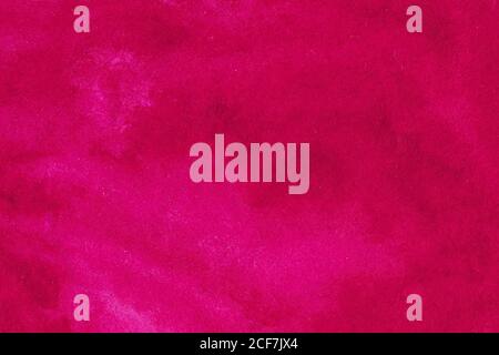 Red ruby color smeared on paper textured background Stock Photo